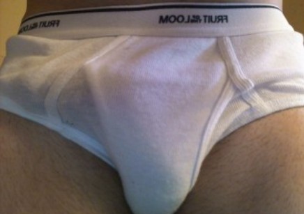 Guy showing how his dick bulges in white briefs.